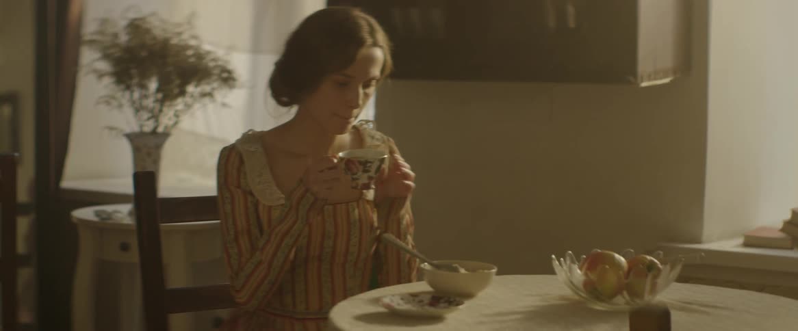 A woman sips from a tea cup