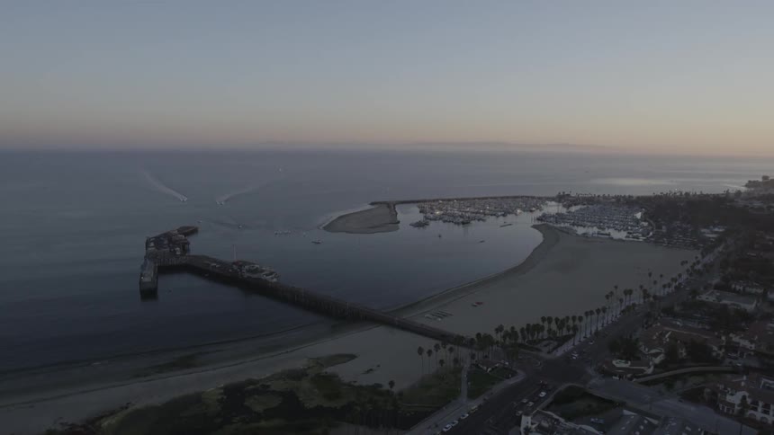 Long docks go out into the ocean near this coastal town