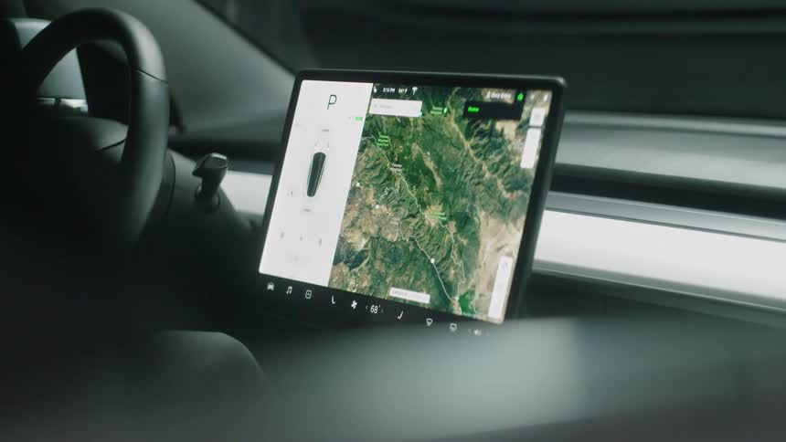 A navigation system is starting up as a person turns on a car
