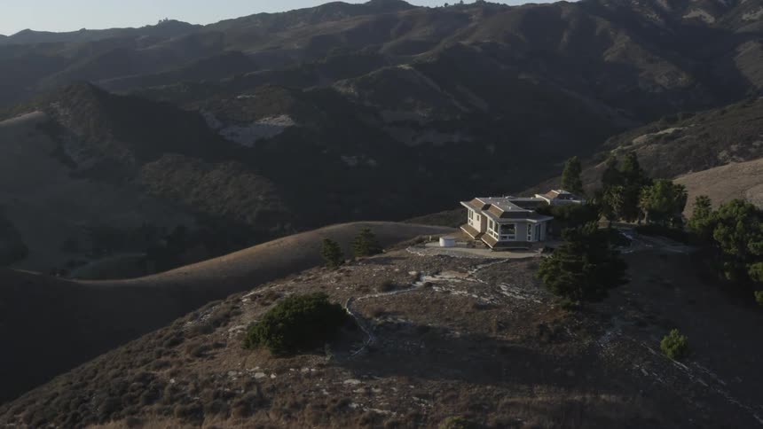 A house sits on top of a mountain