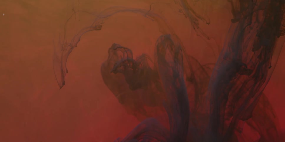 A dark liquid swirls and flows