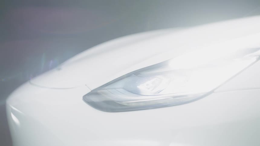 Headlight flashing on a white car
