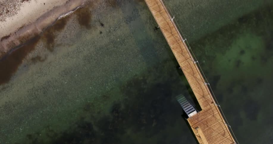 A dock extends into ocean water