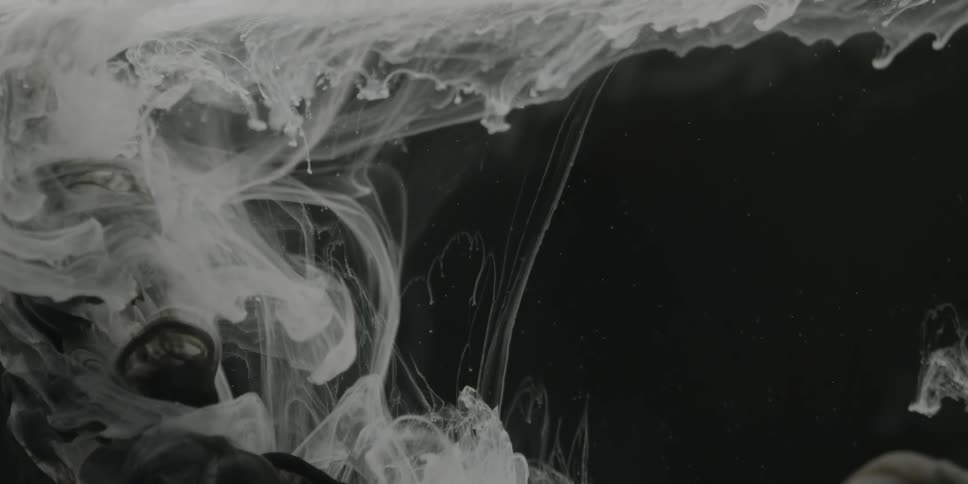 White clouds plume into liquid