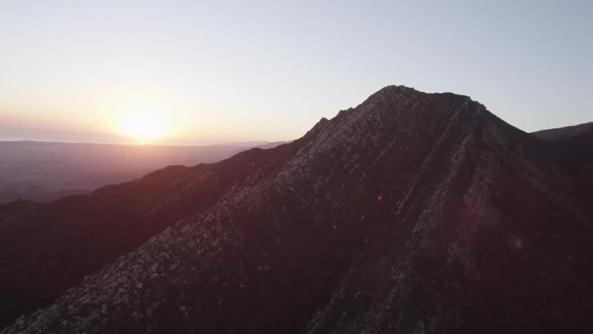 Aerial view of a large mountain as the sunsets