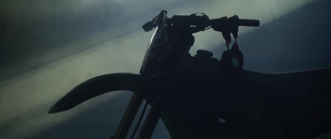 A dirt bike is parked in a dusty garage
