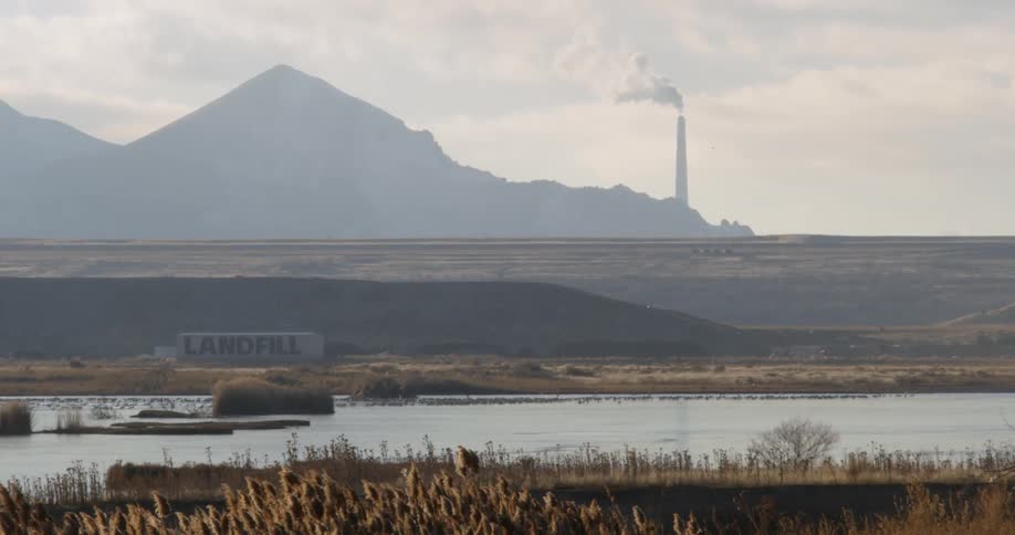 A river flows by a landfill