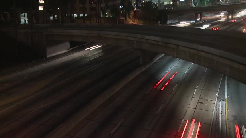 Cars are driving under the bridge