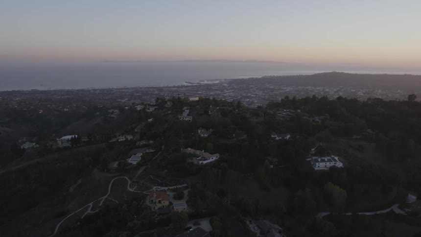 A city is shown at dusk