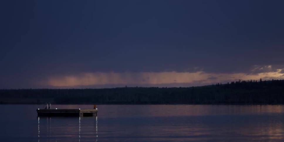 A light flashes on a wood platform in the water