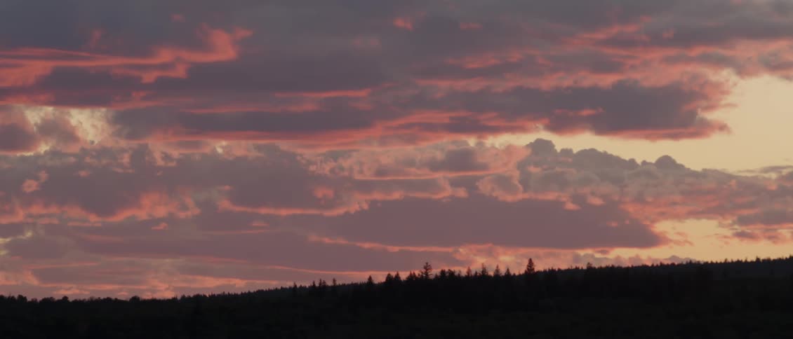The sky is full of clouds at sunset