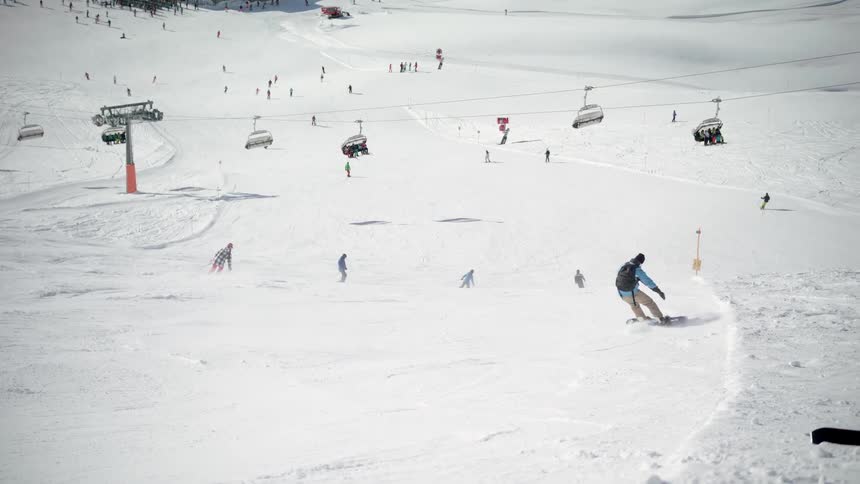 Skiers ski down the slope
