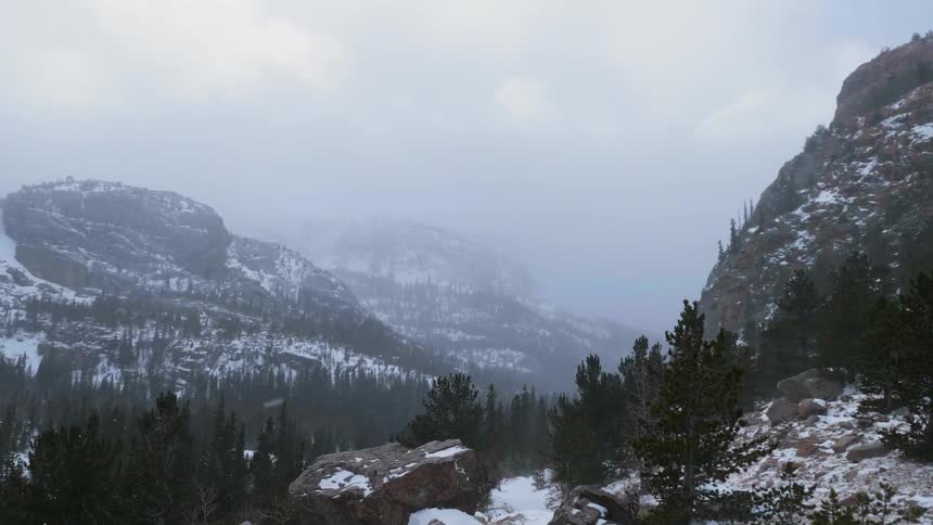 Snow falls on the mountains