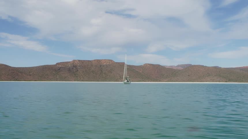 The boat is alone moving in the water