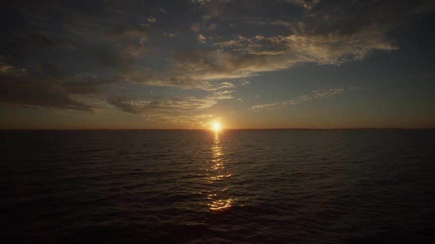 Sun sets over a flowing lake
