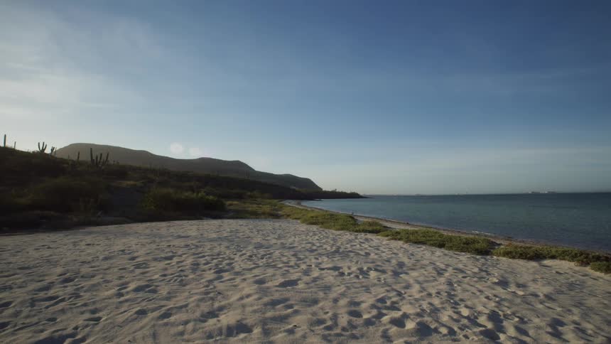 Small waves coming ashore on a sandy beach
