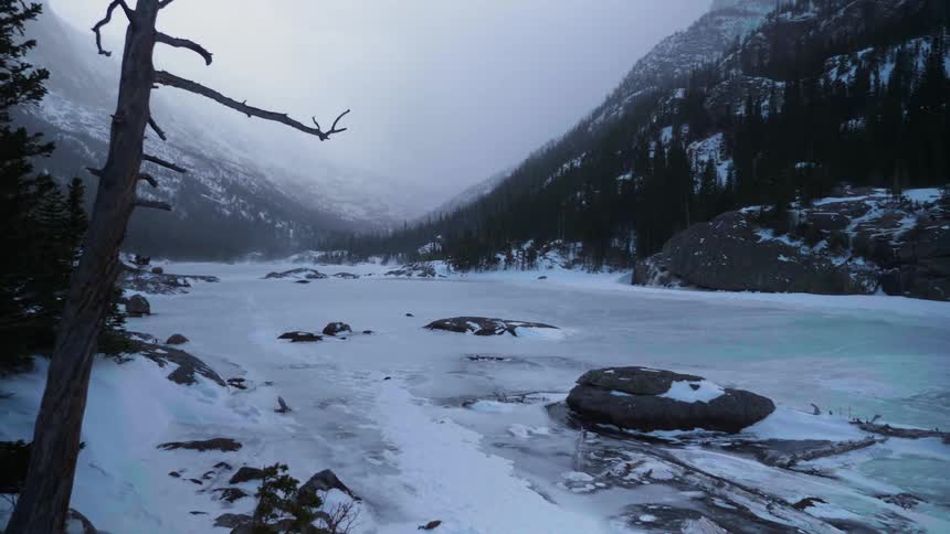 Fog hanging over forest and frozen river