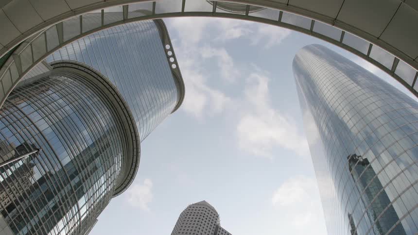 Clouds float over city skyscrapers