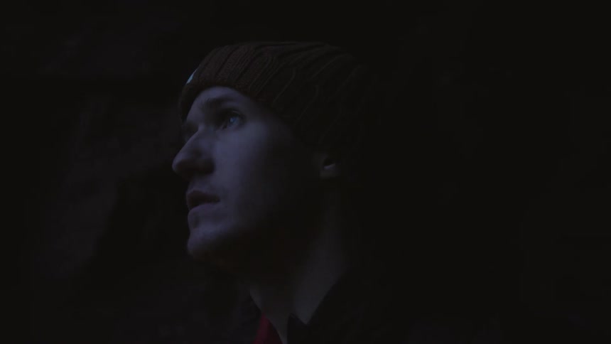 A man is looking around in the dark