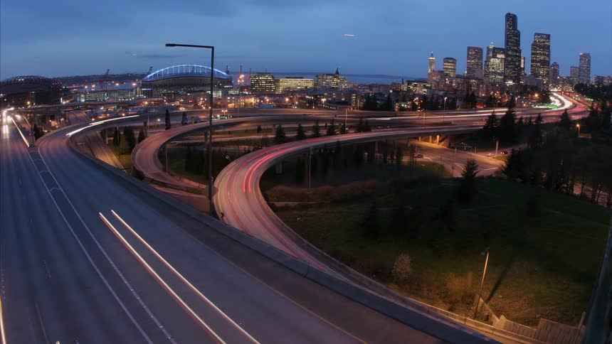 Traffic moves throughout a downtown area of a city on elevated roadways