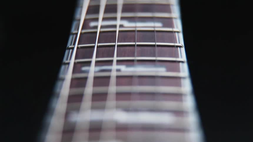 Close up view of a guitar fretboard