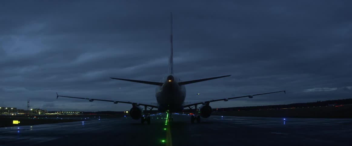 Airplane lands on an airstrip at night