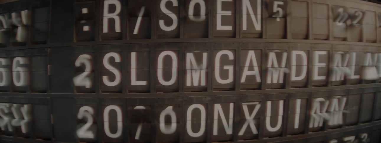 Numbers and letters on a travel information board are rotating into place