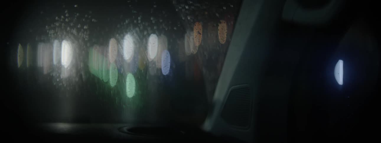 A car drives through the rain