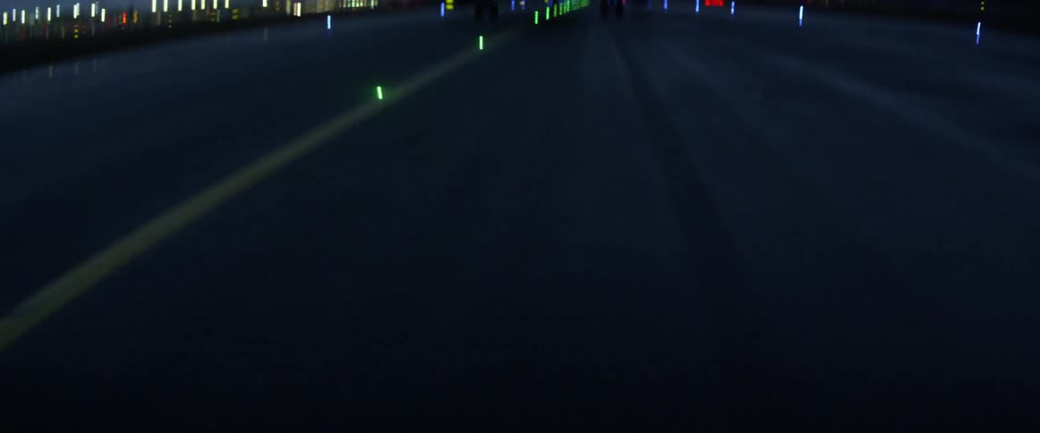 An airplane is traveling down a runway at dusk