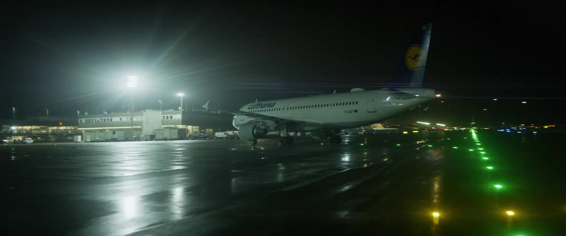 Airplane takes off at an airport at night