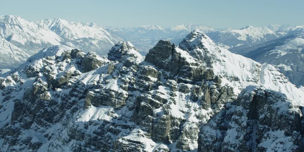 Snow covers a rocky mountain peak