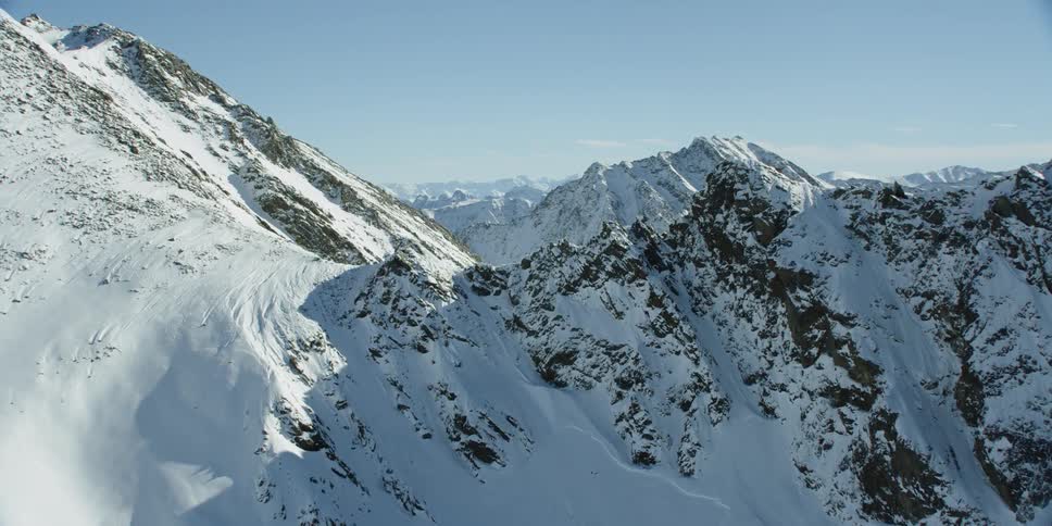 Snow covered mountain range on sunny day