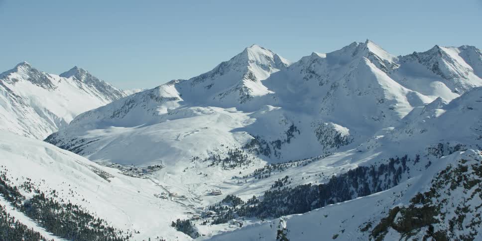 Sun shines down on snowy mountains