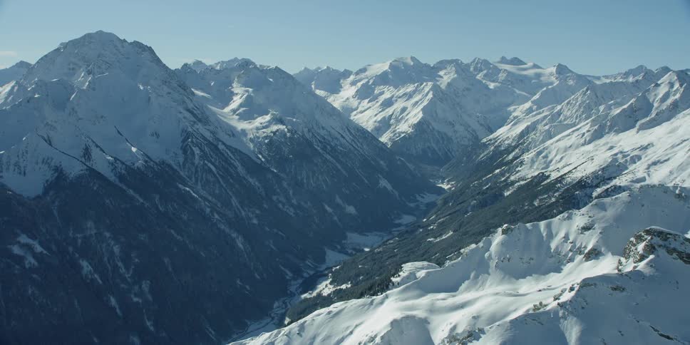 Sun shines down on snowy mountains