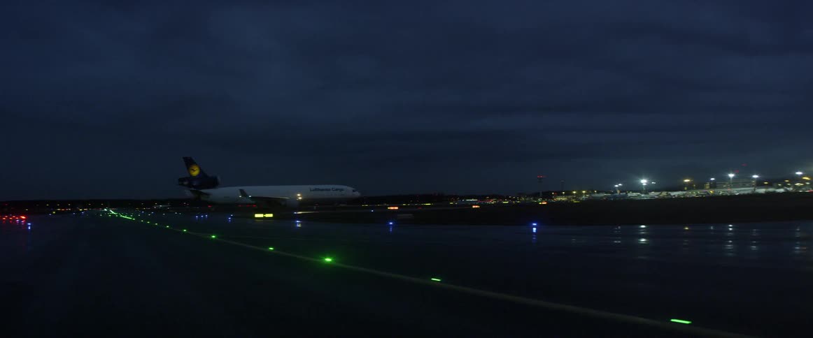 Airplane sitting on runway at airport at night