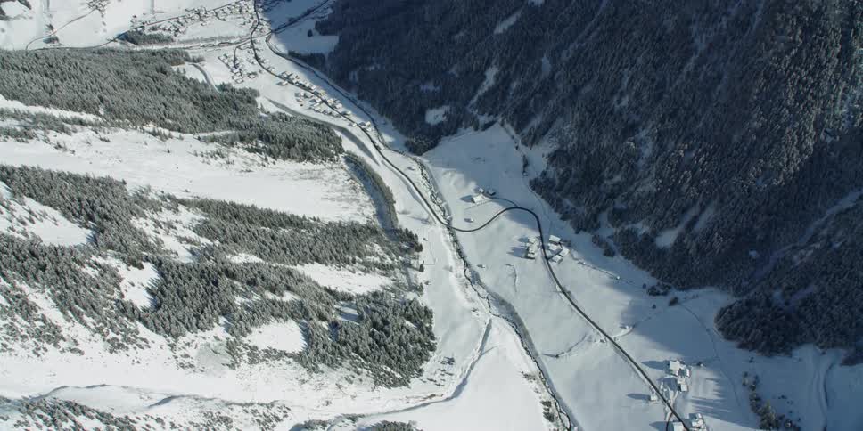 Paths in the snow through a valley