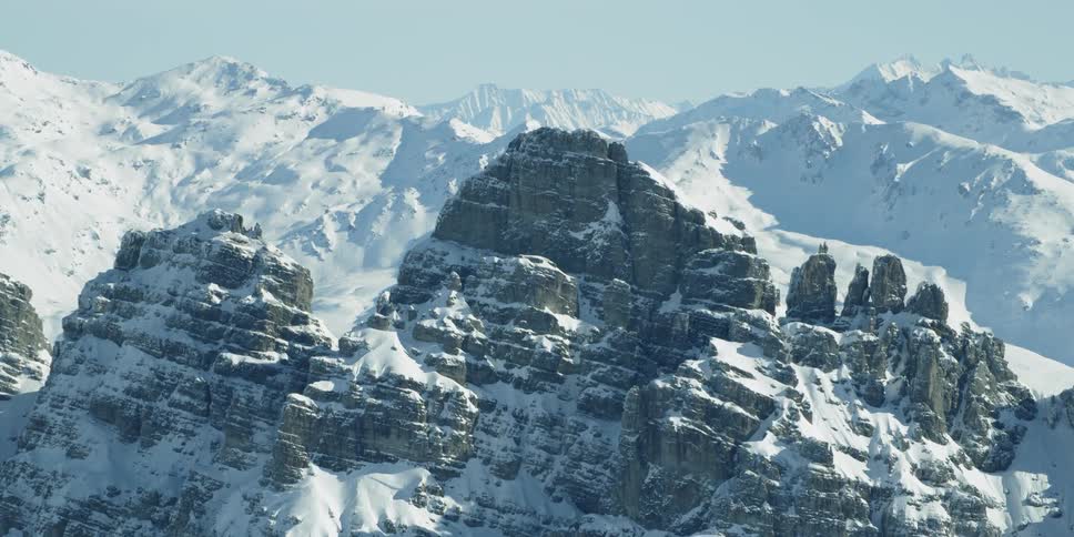 Snow covered mountain range on sunny day