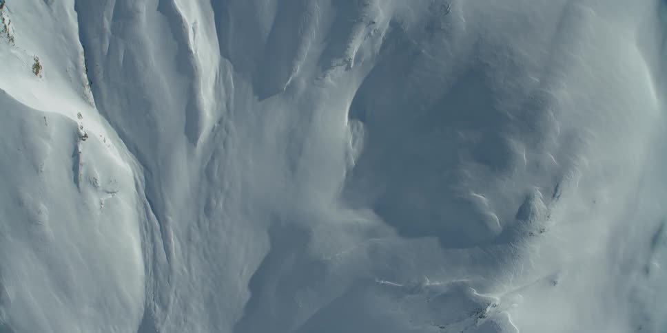 Snow covers a mountain ridge