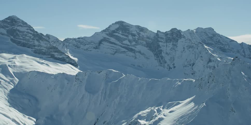 Snow covered mountain range on sunny day