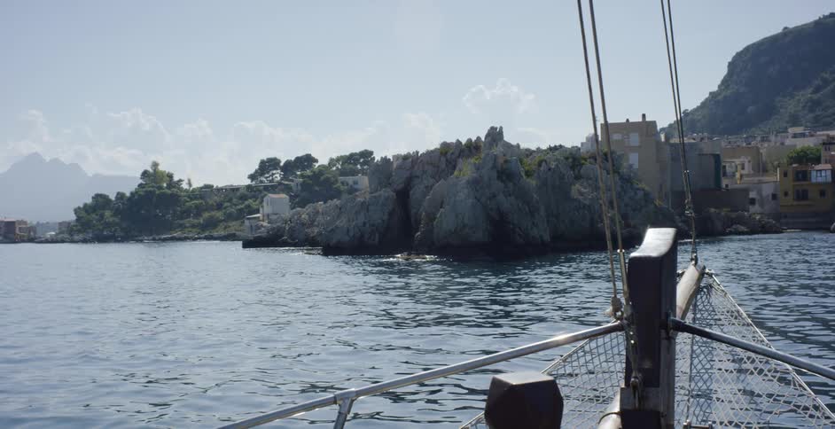 Boat navigates towards populated bay area
