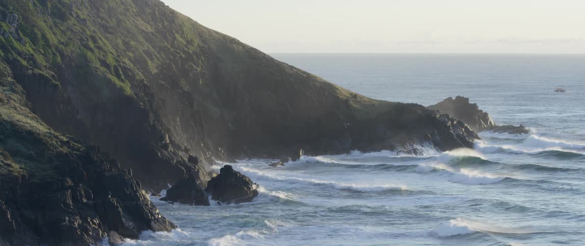 Waves crashing on a rocky cliff side