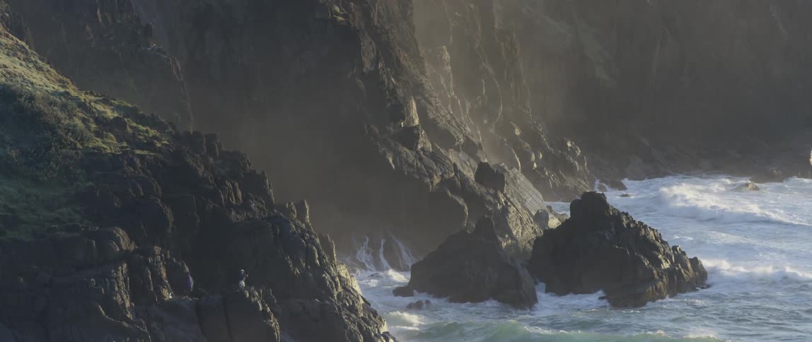 Waves crashing on a rocky cliff side
