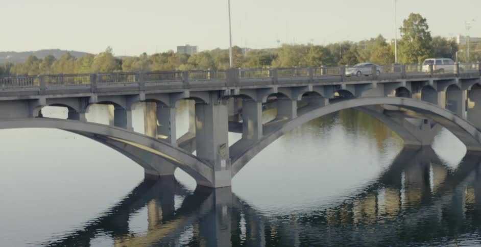Cars drive over a bridge