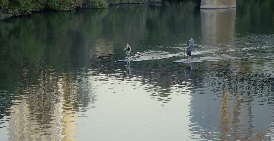 People paddle board on a lake