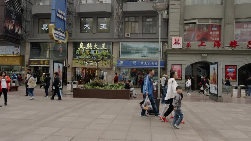 People walk and shop in a city plaza