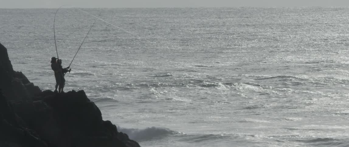 People are fishing off the rocks