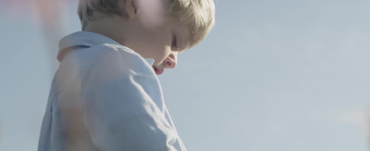 The child is examining some flowers