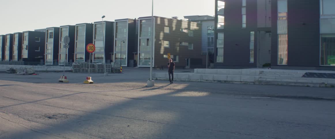 A man talks on the phone while walking outside