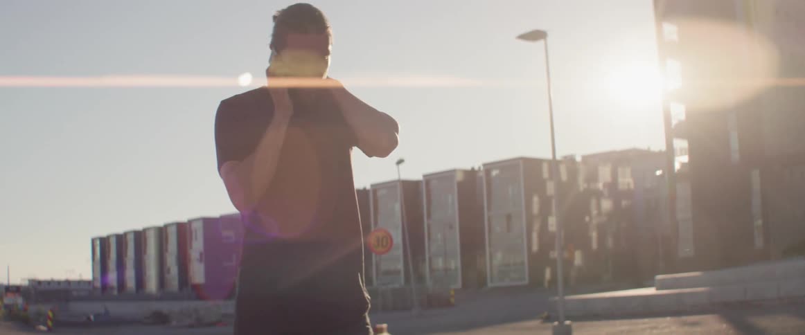 A man uses his phone while walking outside