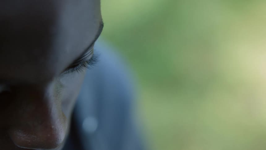 A boy looks down at something